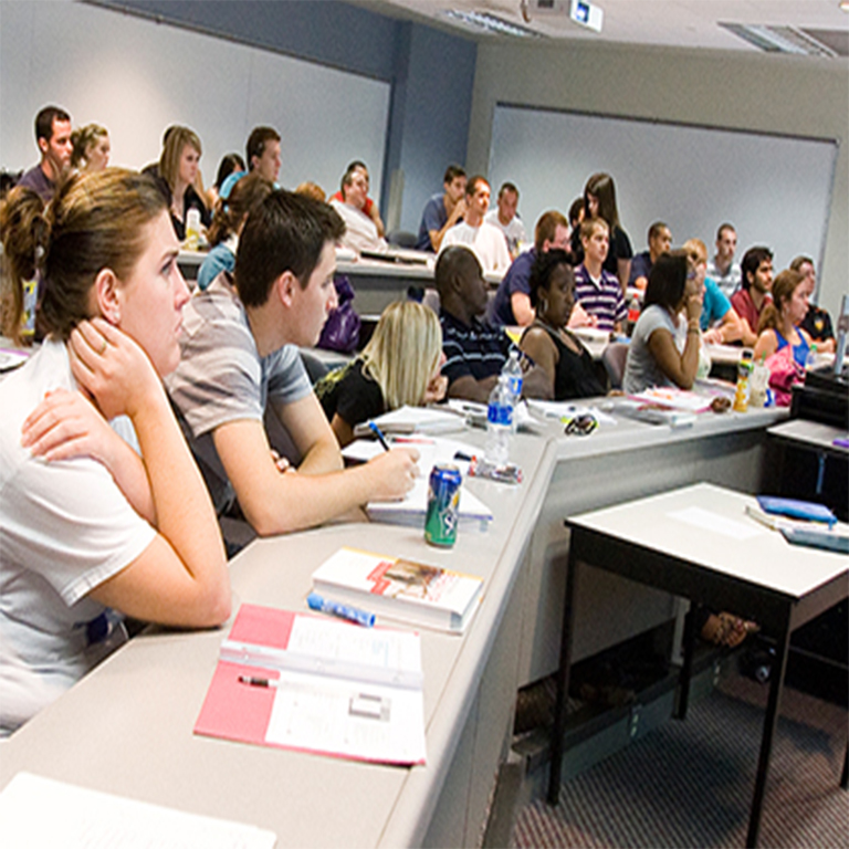 Students listening in a lecture hall.