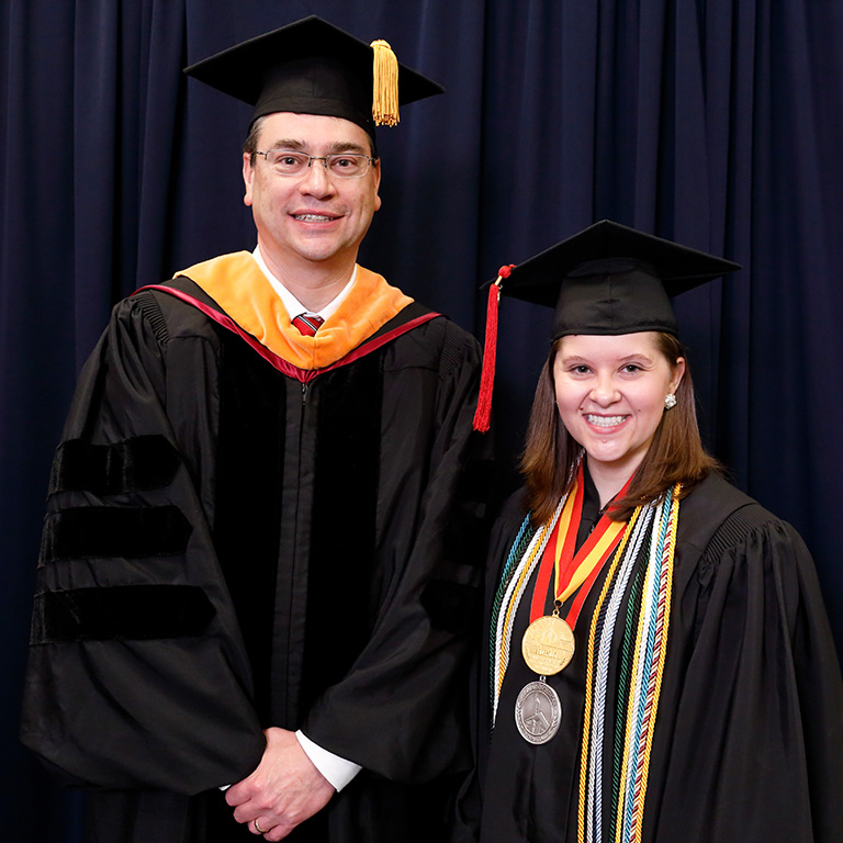 Amber Kriech and a guy at commencement.