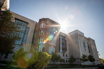 Scenic picture of Ivy Tech Indianapolis building with sun shining behind building